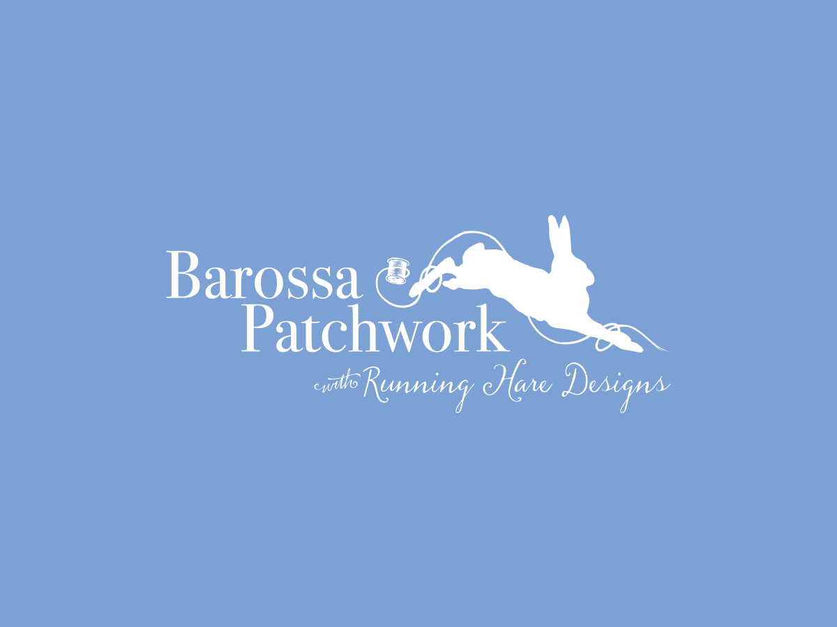 A logo with a blue background features white text that reads "Barossa Patchwork with Running Hare Designs." The text has a silhouette of a jumping hare holding a thread spool.